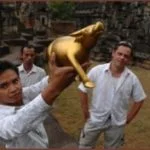 CamboFest Grabay Meas Golden Waterbuffalo trophy award: CamboFest staffer Phun Sokunthearith holds the Grabay Meas (Golden Waterbuffalo) award, while CamboFest founder and filmmaker Jason Rosette and staffer Narith Hoo look on.